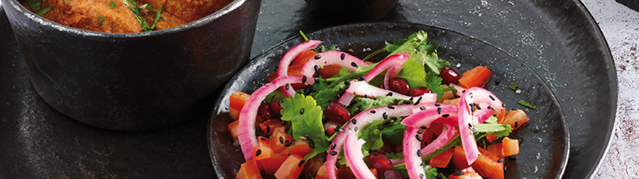 close up of a colourful salad on a dark plate