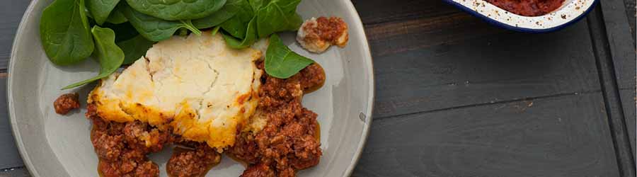 Shepards pie on a plate with veg
