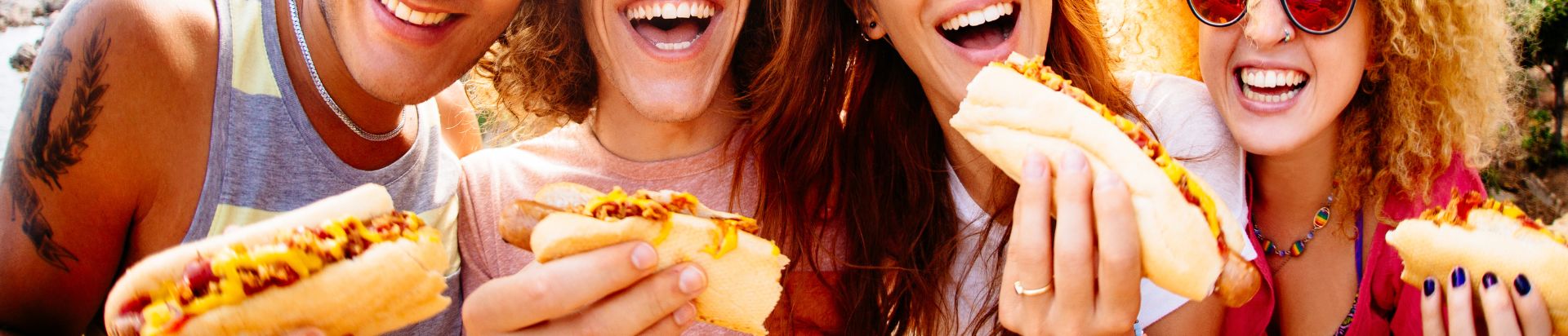 People enjoying hot dogs
