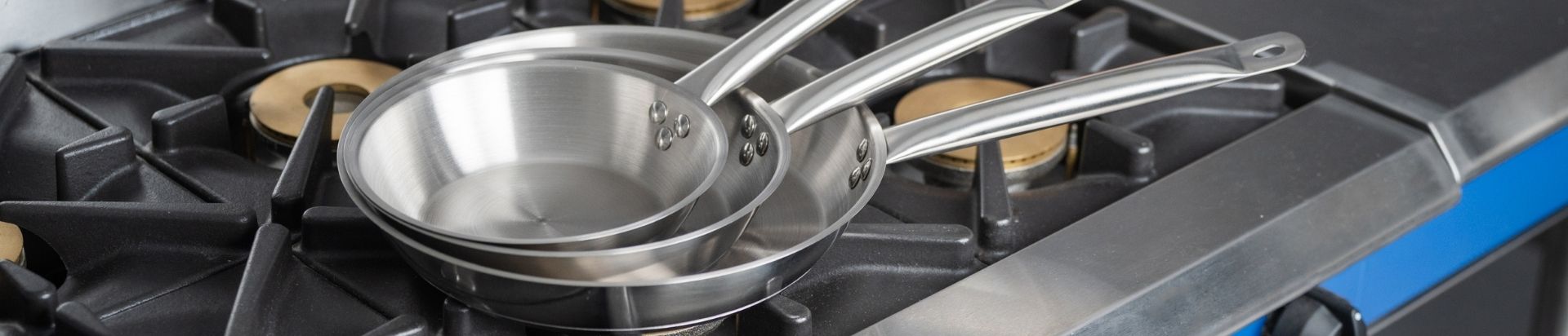 Stack of frying pans on gas burner range
