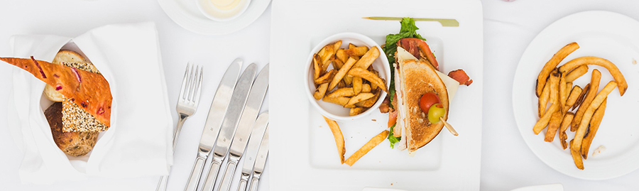 Chips and sandwiches on white plates