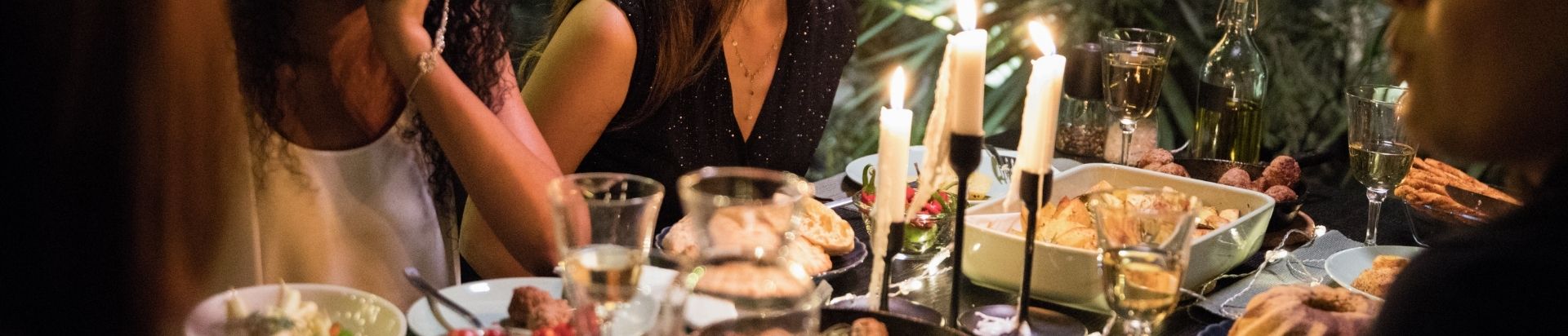 People sharing a meal round a table