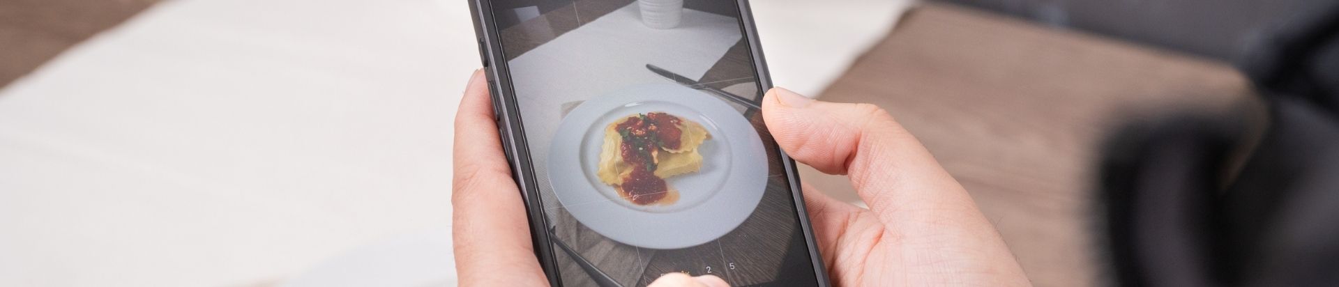 Person taking photos of their food
