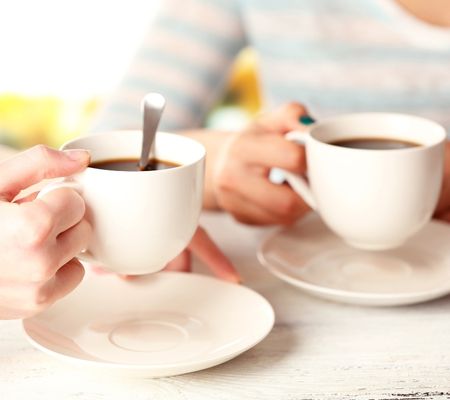 Two people with mugs of tea