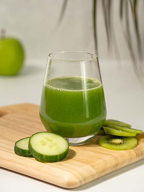 Glass with green juice in it