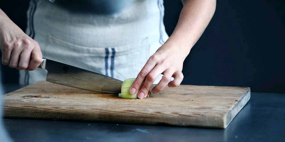 chef cutting an onion