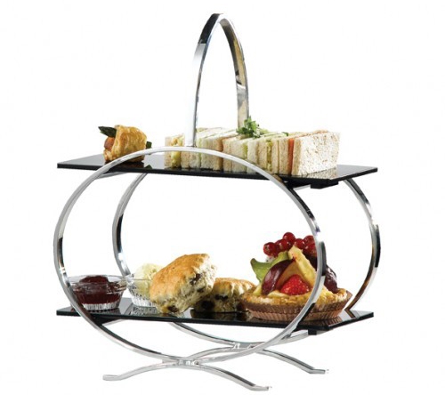 Cake stand with sandwiches and cakes on