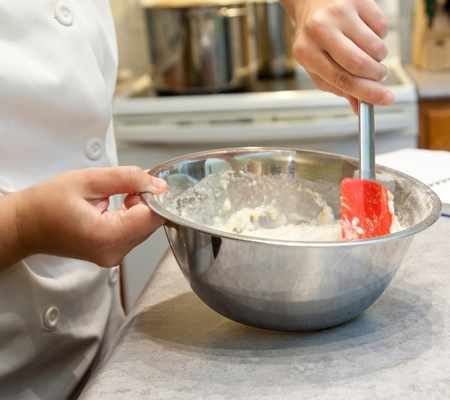 chef mixing food in a bowl