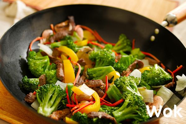 Wok with mixed vegetables in it