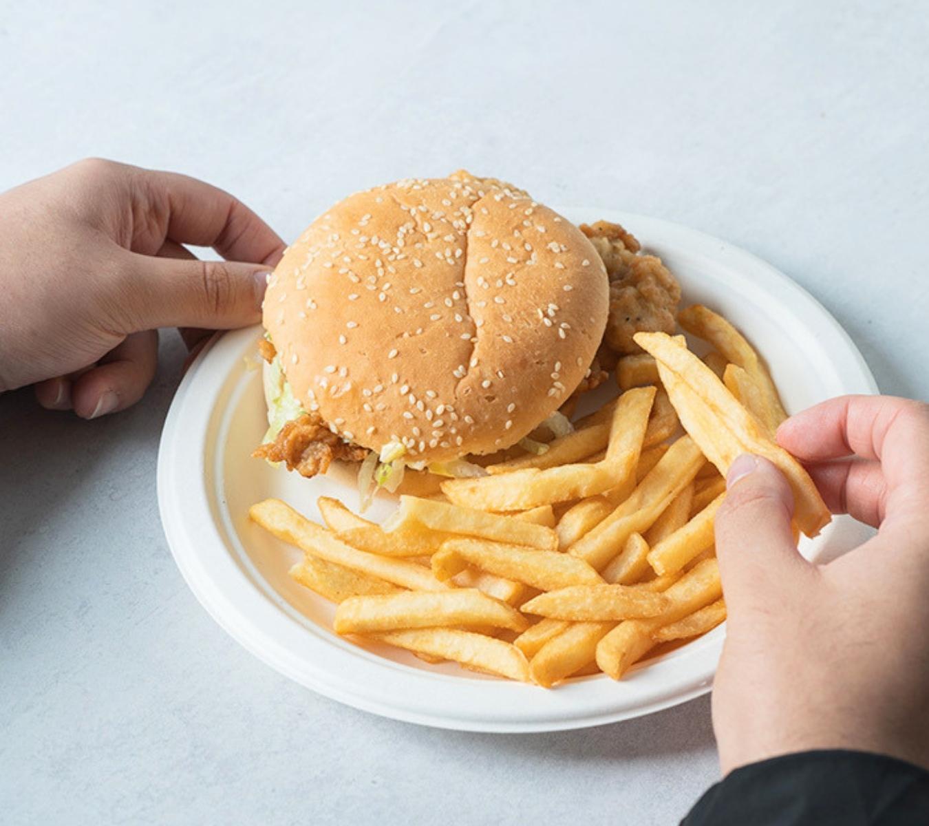 Burger and chips on a bagasse plate