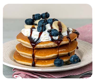 Pancakes with berries and maple syrup