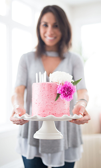 A woman holding a cake