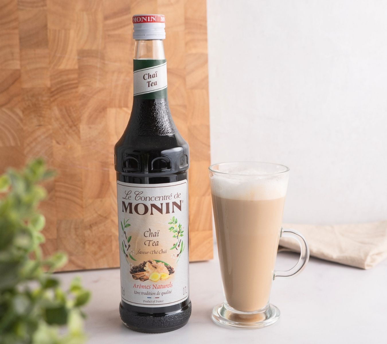 Chai tea with a bottle of Chai Monin syrup