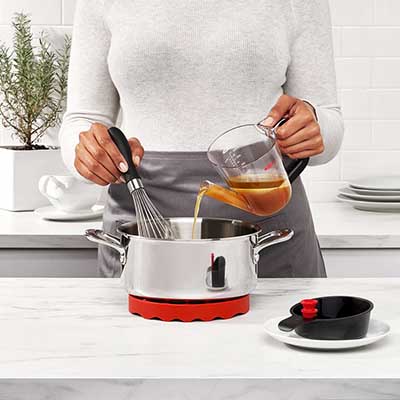 Pouring chicken juices into a pan