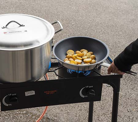 Outdoor cooking burners in use