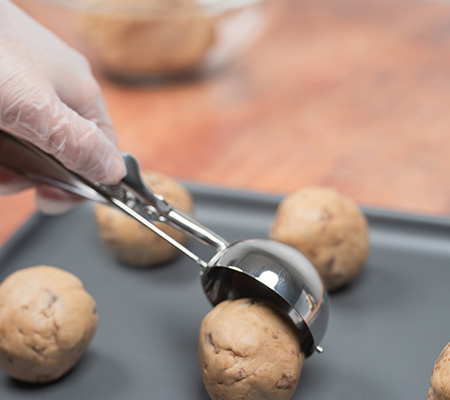 Cookie dough being portioned before baking