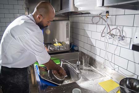 A chef washing up