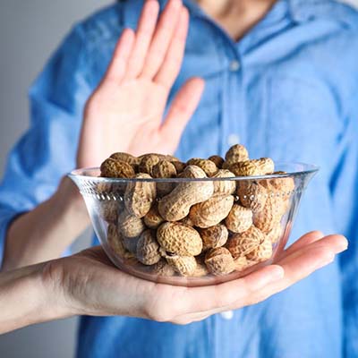 Person saying no to peanuts