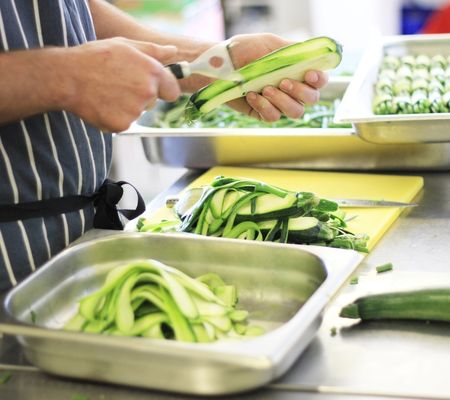 Peeling vegetables into a gastronorm container