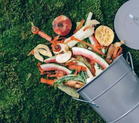 Food waste spilling out of a bin