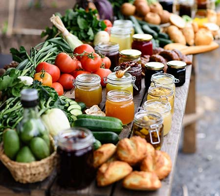 Local food market with veg, honey, and jams