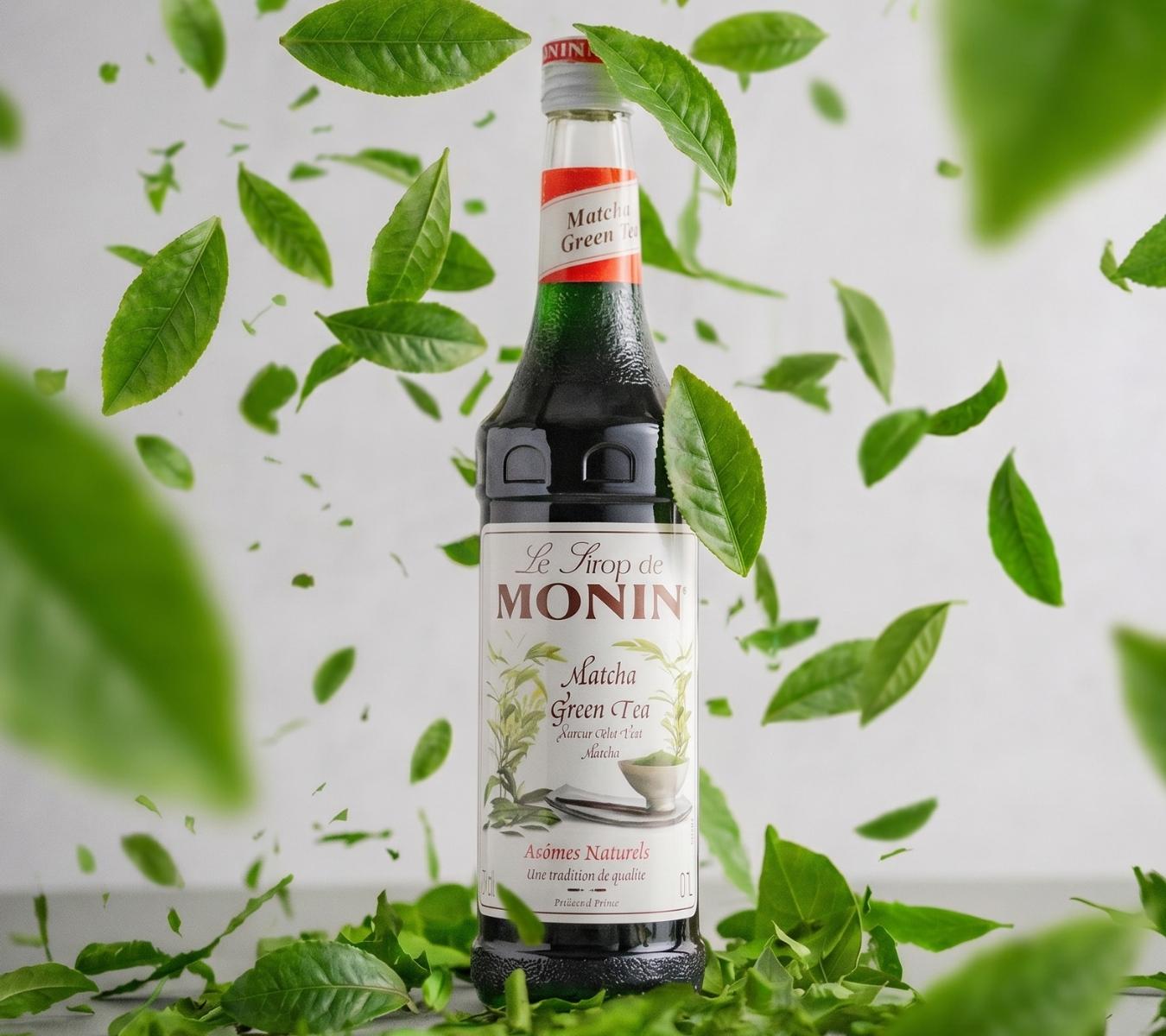 Bottle of Monin Match Syrup with leaves falling