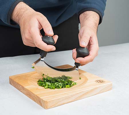 Using a mezzaluna to chop herbs