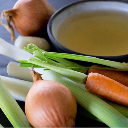 Soup surrounded by vegetables