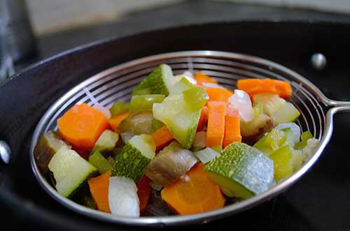 Chopped vegetables in a strainer