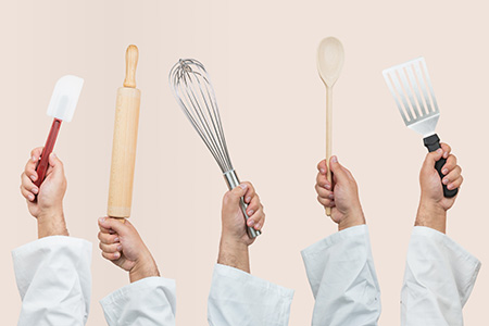 Chefs holding utensils