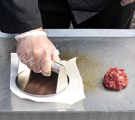 Smash burgers being cooked